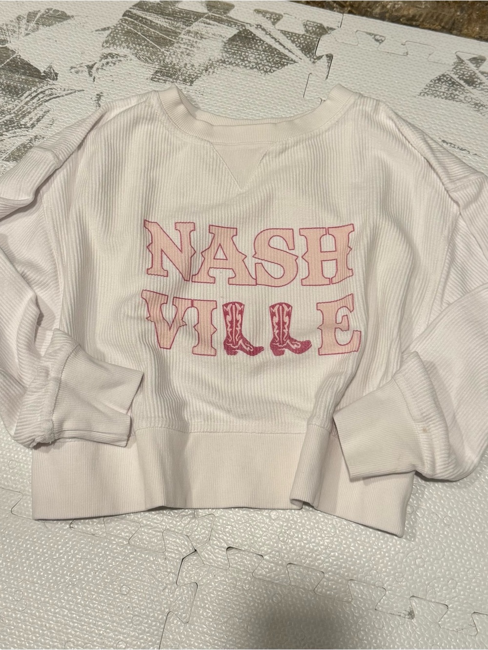 Pink Lily White Nashville Graphic Chord Ribbed Sweatshirt with Pink Lettering.